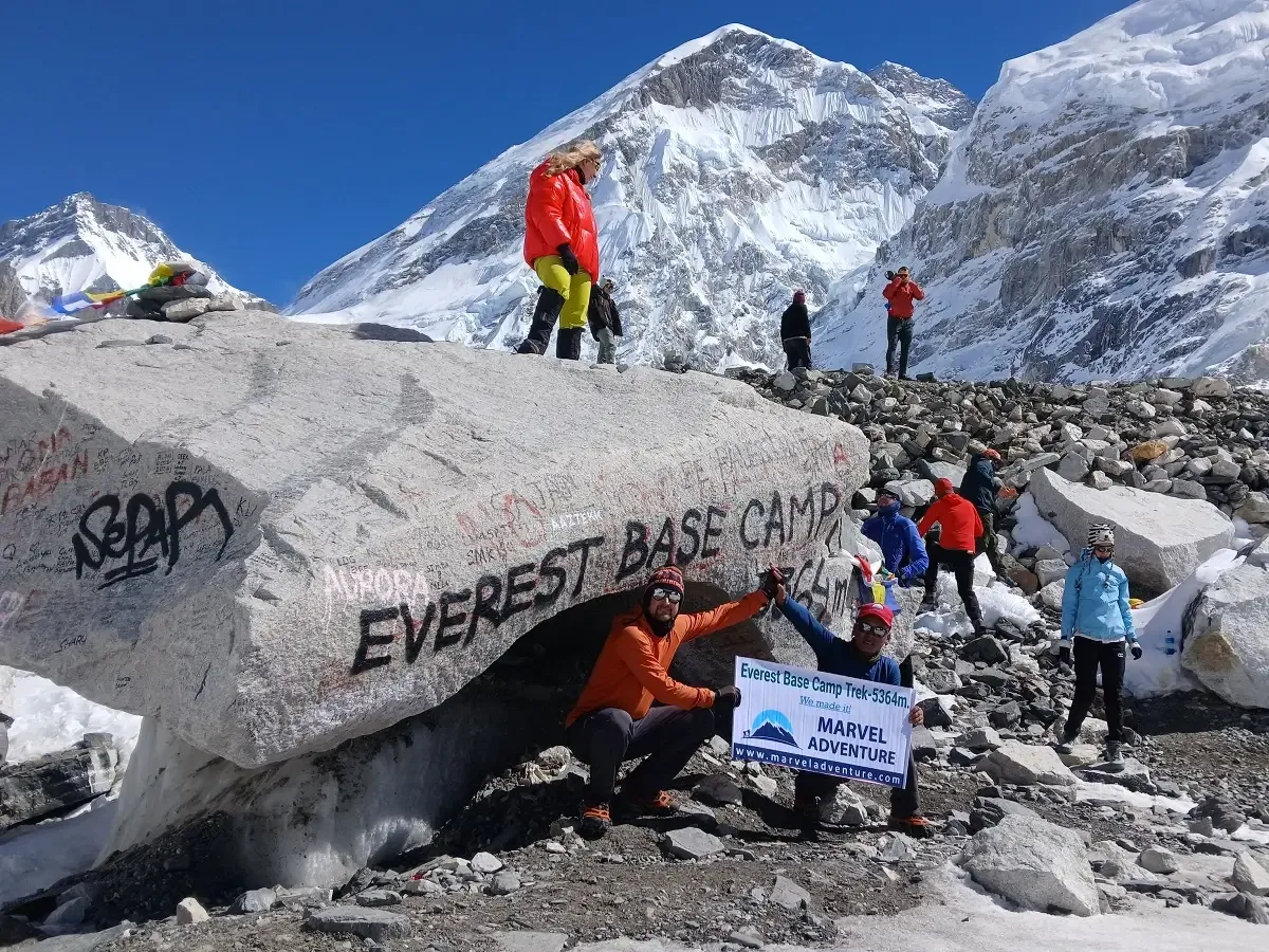 trekkers celebrating at everest base camp