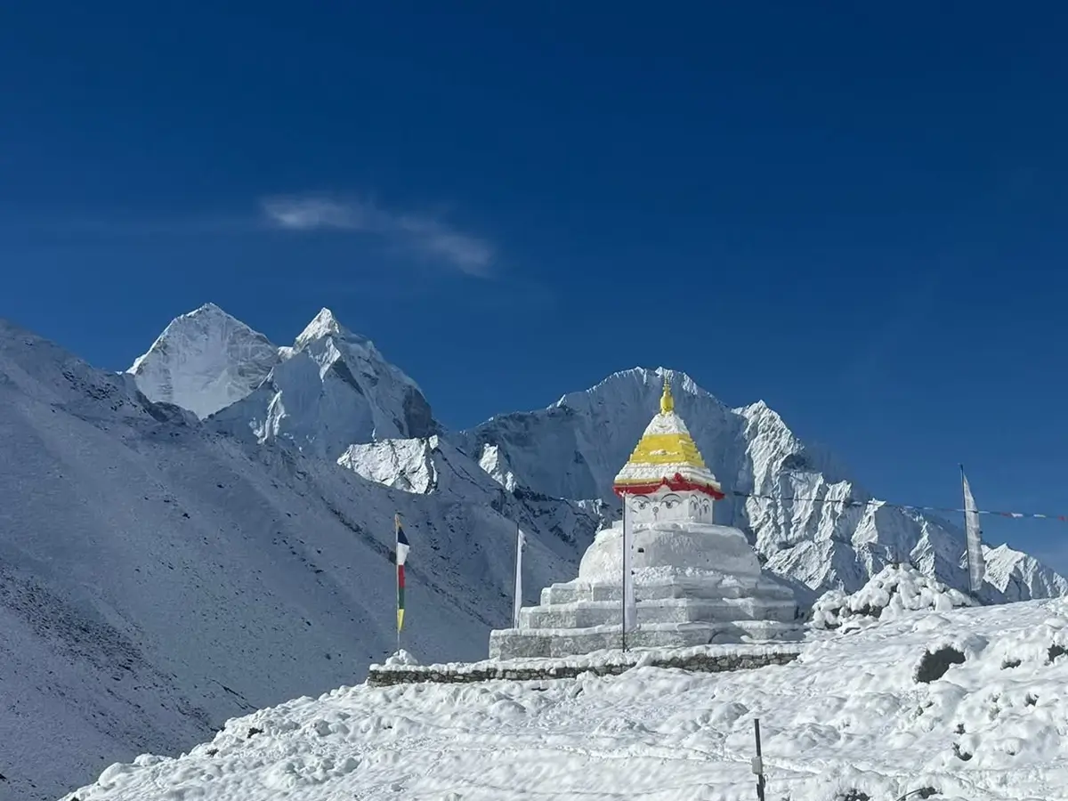 Snow-covered stupa and Himalayan peaks near Nangkartshang Peak above Dingboche