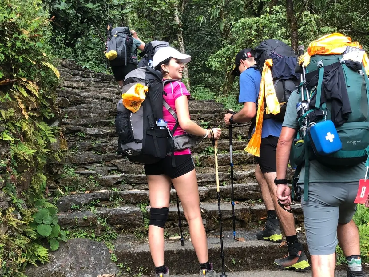 trekkers climbing stone steps during trek